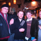 Mike Fahey of Kotaku stands next to Michael McWhertor and Luke Plunkett in a bar.